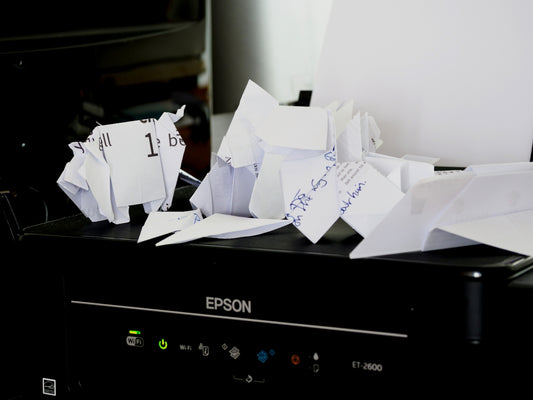 a pile of papers sitting on top of a black box