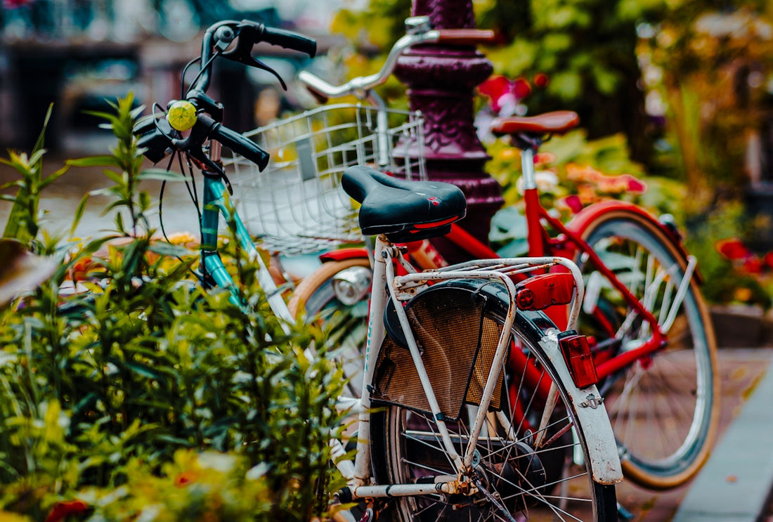 A red bicycle parked next to a red fire hydrant