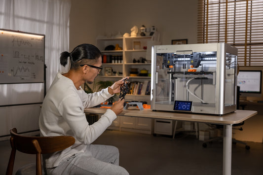A woman sitting in front of a computer screen