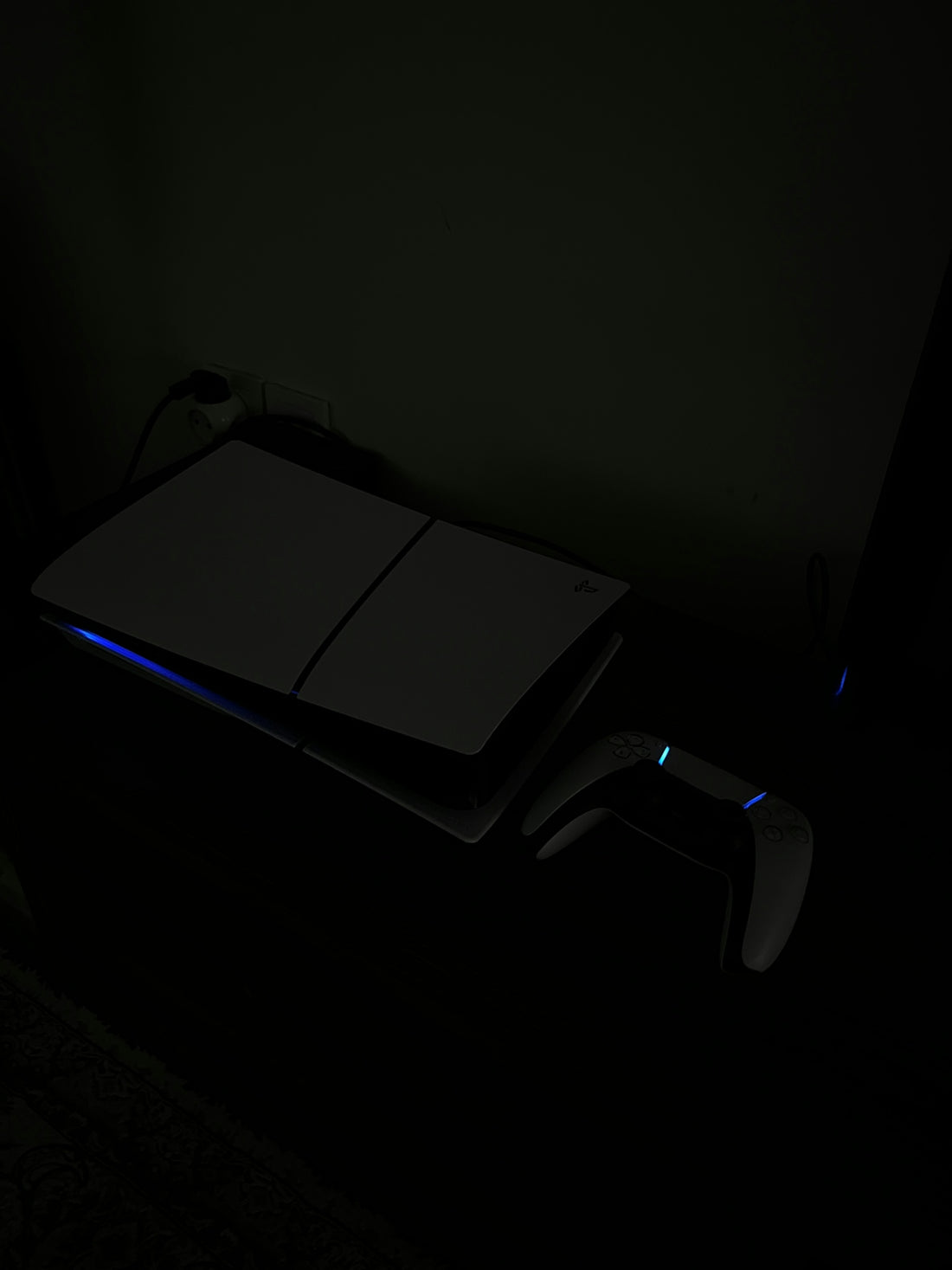 A laptop computer sitting on top of a desk in a dark room