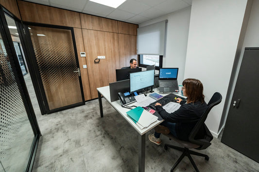 People work at desks in a modern office.