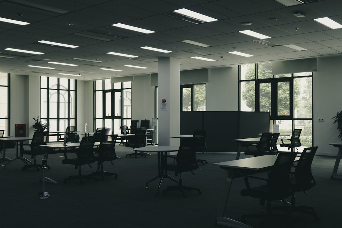 Empty modern office space with tables and chairs.