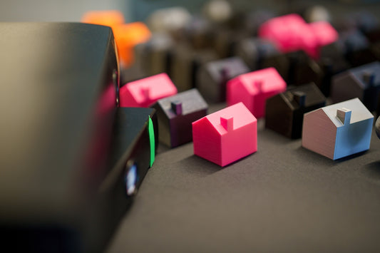 Many small colorful houses arranged in rows.