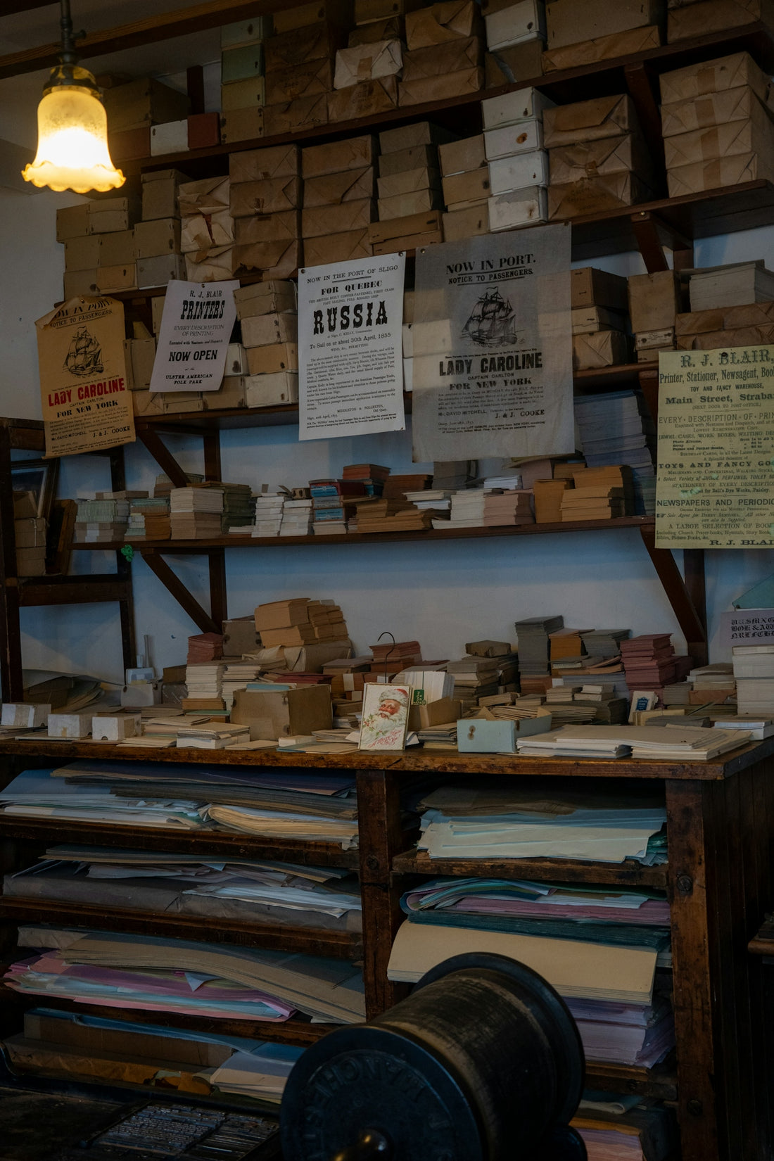 Shelves filled with boxes, papers, and vintage advertisements.
